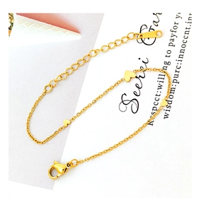 Detail view of gold-plated love heart charms and adjustable lobster clasp chain