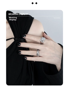 Detail shot of irregular lava texture rings in S925 silver on hand with black styling
