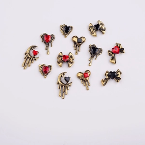 Gothic gold alloy nail charms with red and black heart gems in bow and moon shapes