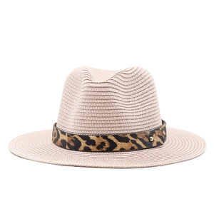 Detailed view of the woven straw texture and leopard print band on the fedora sun hat