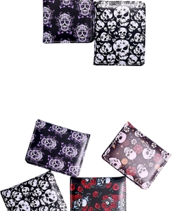 Detailed flat lay of gothic bifold wallets with skull, spider, and rose printed patterns