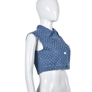 Side view of distressed blue denim vest with heavy wash and ripped details on a mannequin