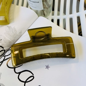 Detail of olive green rectangular hollow hair claw clip with sturdy metal spring