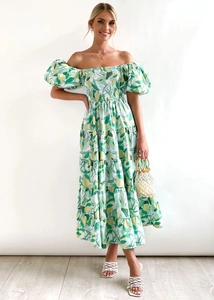 Detail of off-shoulder floral dress featuring puff sleeves and a tiered flowing skirt