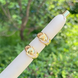 Detail of 18K gold plated heart ring with sparkling cubic zirconia on a white pen