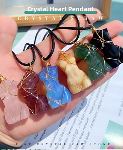 Detail of handcrafted wire-wrapped torso crystal pendants in various natural colors
