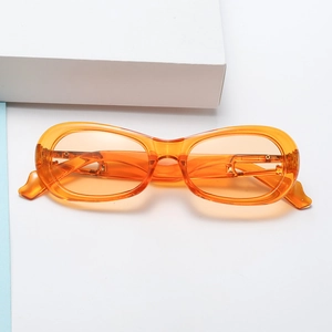 Detail view of retro translucent orange oval frame sunglasses with thick plastic design