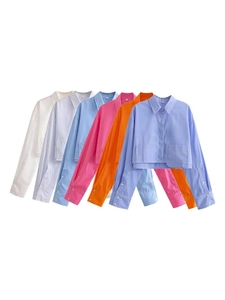 Flat lay of colorful long-sleeve crop shirts in various stripes and solid colors