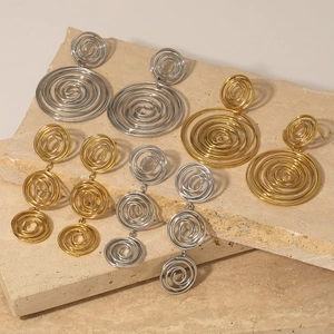 Elegant gold and silver spiral thread earrings set on stone for versatile styling