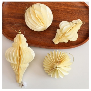 Detailed cream honeycomb paper Christmas tree ornaments on a natural wooden tray decor