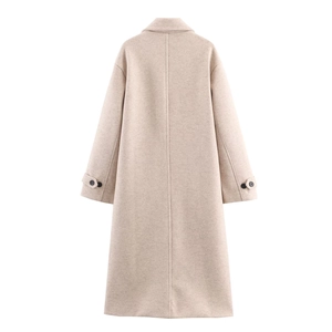 Close-up of oatmeal wool coat back showing H-line cut and adjustable cuff straps