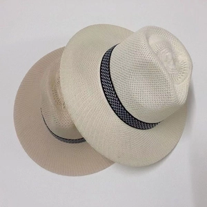 Detail of cream and khaki straw hats featuring geometric patterned decorative bands