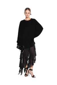 Detailed view of black knitted sweater with irregular lace hem and sheer chiffon skirt