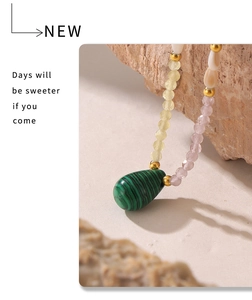 Detail of malachite heart pendant with pearls on 18k gold plated stainless steel chain