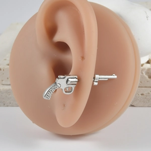 Vintage silver pistol shaped stainless steel earring stud on a silicone ear model