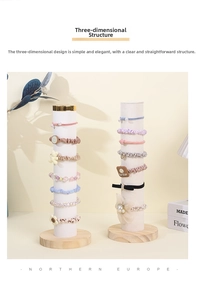 Detail of assorted velvet scrunchies and hair ties on a professional wooden display stand