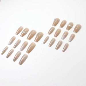 Nude ombre press-on nails with silver glitter and rhinestones in coffin shape