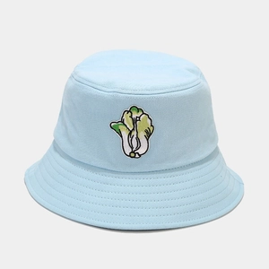 Close-up of high-quality cotton canvas fabric and vegetable embroidery on light blue bucket hat
