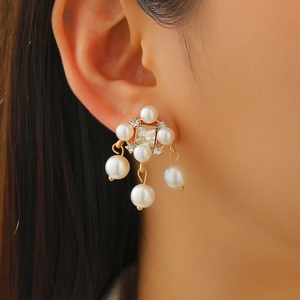 Close-up of vintage multi-layer pearl tassel earrings with gold-plated rhinestones