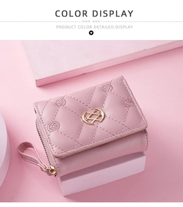Detail of pink embroidered trifold wallet featuring golden logo and zip pocket