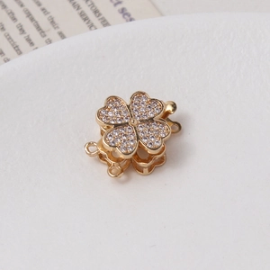 Detailed view of gold clover connector clasp with white cubic zirconia for DIY jewelry
