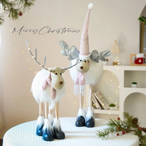 Pink and white Christmas reindeer figurines with LED lights in a cozy Nordic style decor