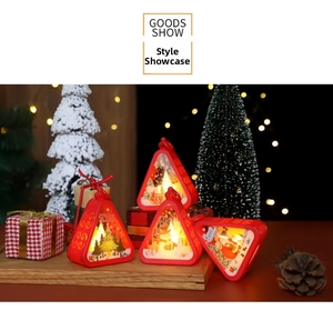 Detail of red Christmas lantern with warm LED light and Santa Clause festive patterns