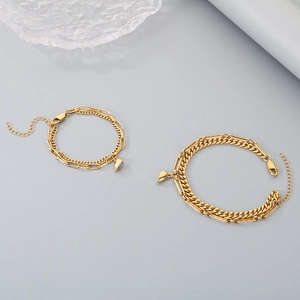Detailed macro view of gold-plated double-layer heart magnet bracelets for couples