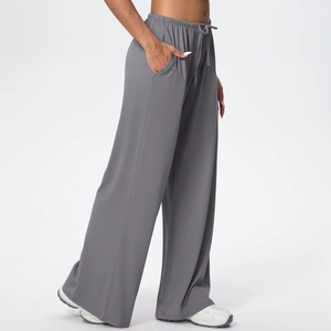 Detail view of dark grey wide leg trousers with elastic drawstring waist and side pockets