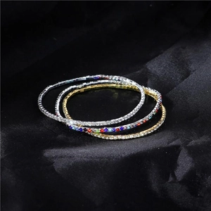 Detailed macro view of four stretch crystal bracelets in gold and silver finish with rhinestones