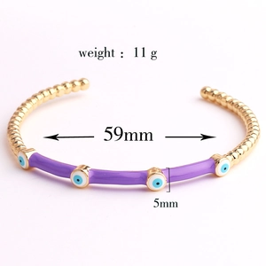 Detail view of purple enamel evil eye bamboo bracelet with 59mm diameter measurement