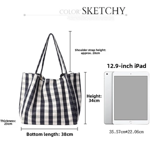 Detail of checkered canvas tote bag with 12.9-inch tablet showing large capacity size