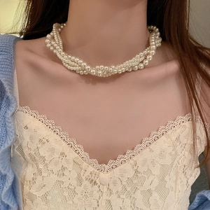 Elegant multilayer baroque pearl necklace for women styled on a model in vintage aesthetic