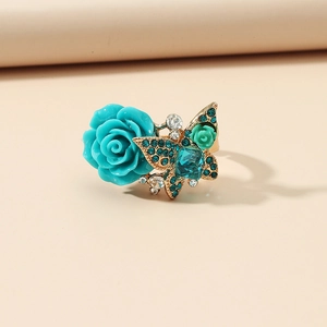 Vintage gold ring with turquoise resin rose and rhinestone butterfly in boho style