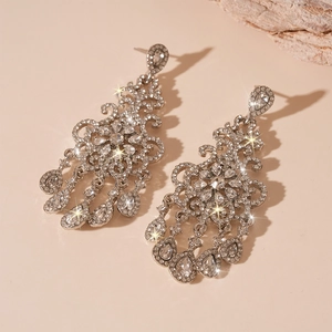 Detailed view of luxury silver chandelier earrings with sparkling pear-cut rhinestones