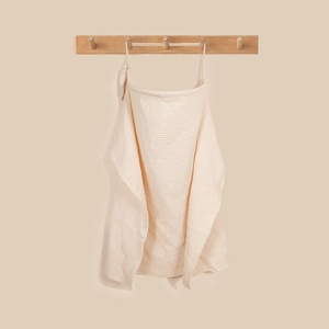 Detail of waffle weave cotton nursing cover with adjustable neck strap in warm beige