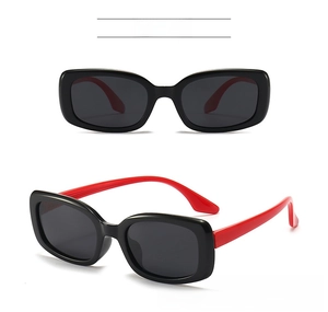 Detail view of kids polarized sunglasses with black frame and red silicone legs