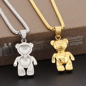 Detailed macro of gold and silver panda pendants with crystal eyes on box chains