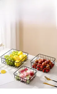Detail of modern black wire mesh fruit basket showing nested storage functionality