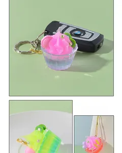 Detailed close-up of miniature dessert cup charms with faux cream and fruit slices