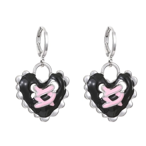 Detail of silver heart earrings with black and pink enamel contrast and wavy silver edges