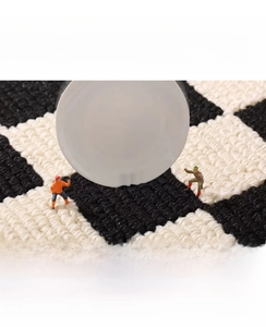 Close-up of woven checkerboard kitchen mat texture showing shock-absorbing property