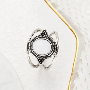 Detail view of a vintage bohemian ring with white stone and oxidized silver finish