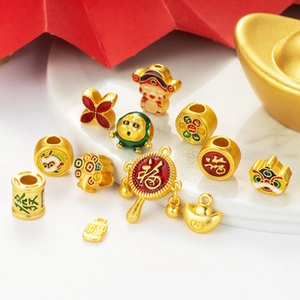 Detailed view of 11 pieces gold lucky charms with red and green enamel for DIY jewelry