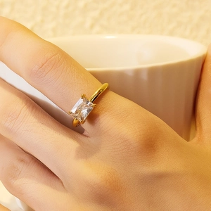 18K gold plated titanium steel ring with a rectangular clear gemstone worn on hand