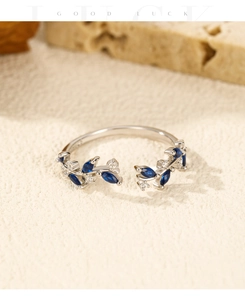 Macro detail of leaf-shaped silver ring featuring marquise blue zircon and sparkling crystals