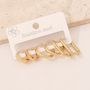 Three pairs of minimalist gold stainless steel geometric stud earrings on a display card