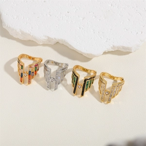 Four elegant wing and letter rings in gold and silver plating with vibrant zircon stones