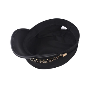 Detail view of the black military hat interior showing size 58 label and gold chain decoration