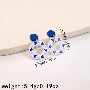 Detail view of blue and white porcelain pattern acrylic hoop earrings with dimensions